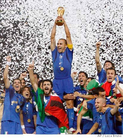 Fabio Cannavaro lifts the World Cup trophy amid confetti with celebrating Italy players after the 2006 final in Berlin